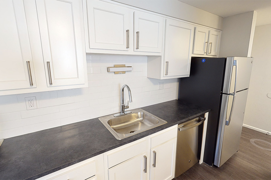 3D tour thumbnail showing kitchen with white cabinets and dark countertops.