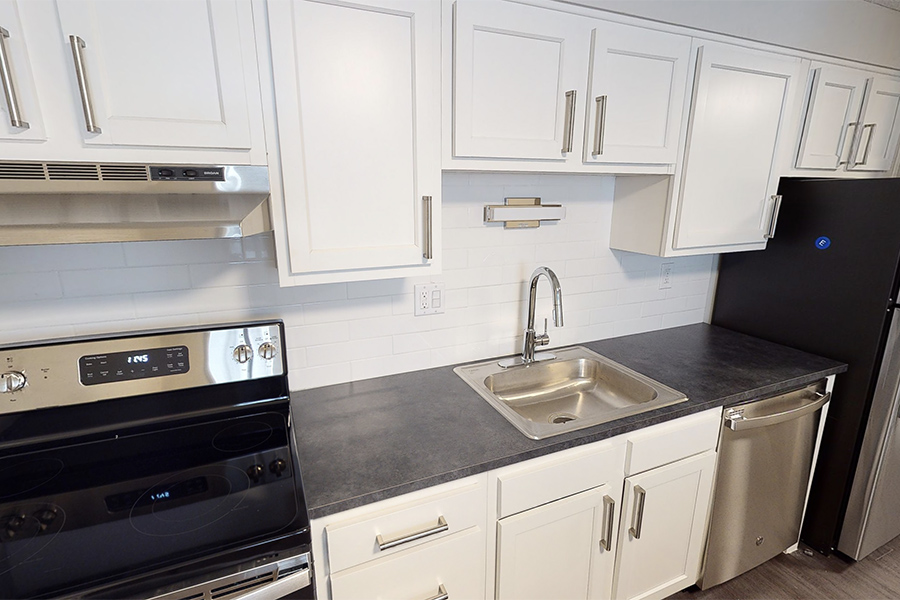 3D tour thumbnail showing kitchen with white cabinets, dark counters, and stainless appliances.