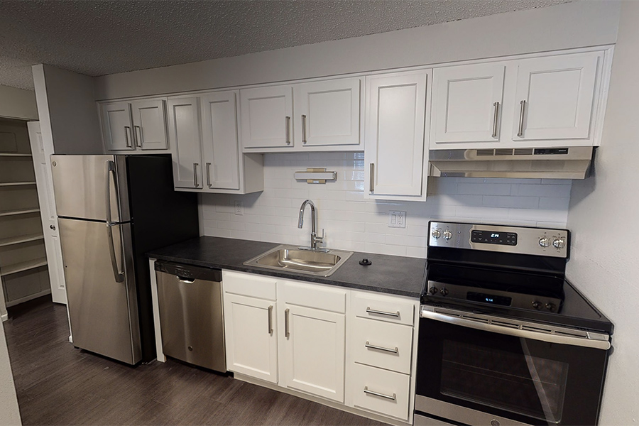 3D tour thumbnail showing kitchen with wood floor, white cabinets, and stainless appliances.