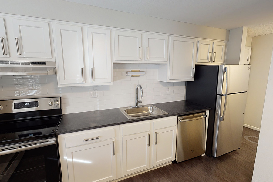 3D tour thumbnail showing kitchen with white cabinets, dark counters, and stainless appliances.