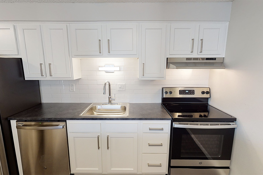 3D tour thumbnail showing kitchen with white cabinets, dark counters, and stainless appliances.