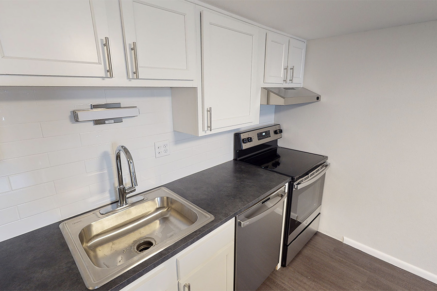3D tour thumbnail showing Kitchen with white cabinets, stainless sink and appliances, and wood floor.