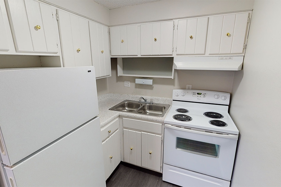3D tour thumbnail showing kitchen with white cabinets and appliances and stainless double sink.