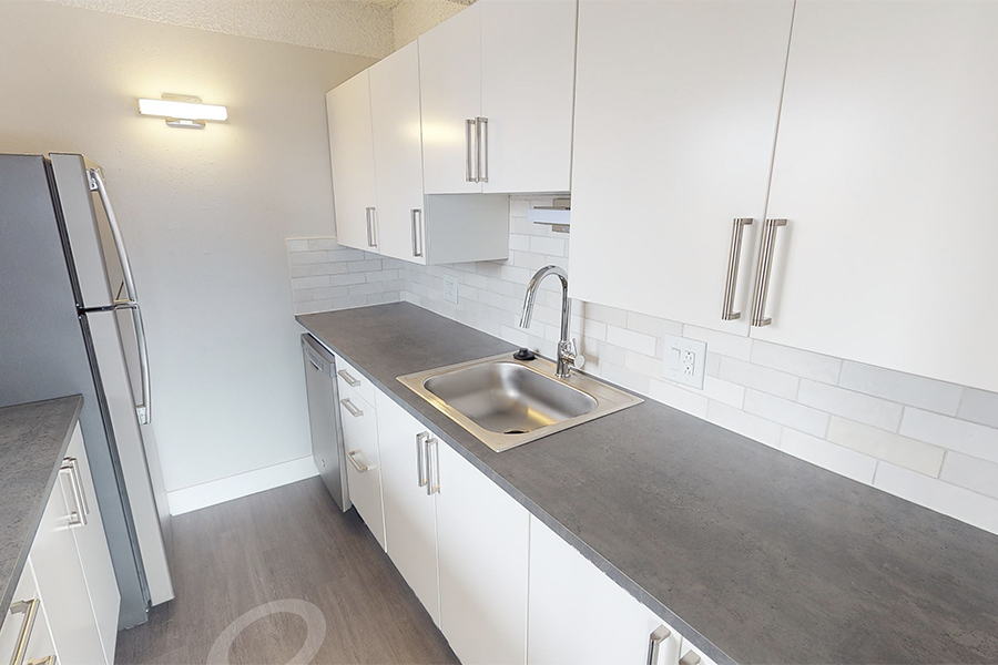 3D tour thumbnail for 1280 Lafayette showing kitchen with wood floor, white cabinets, and dark counters.