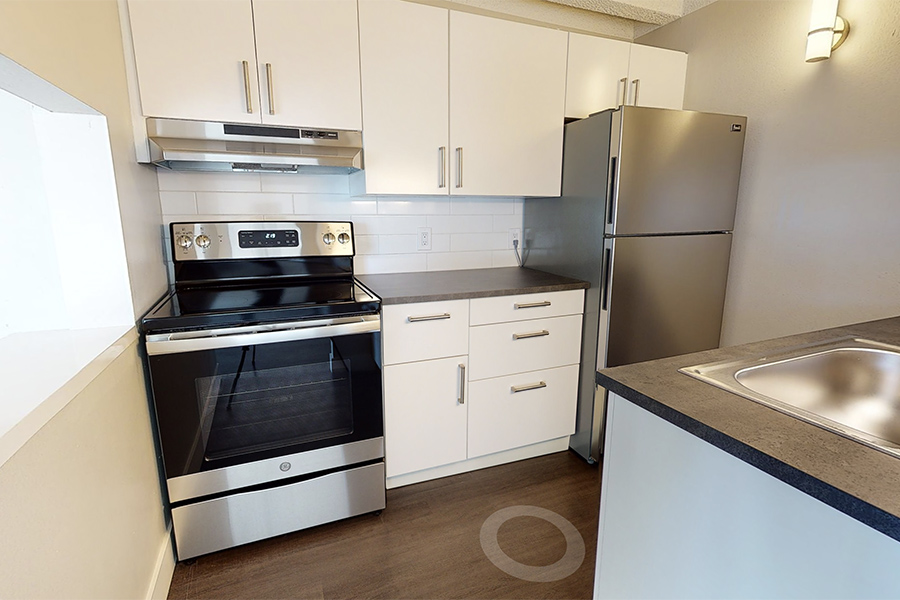3D tour thumbnail for 1280 Lafayette showing kitchen with wood floor, white cabinets, and stainless steel appliances.